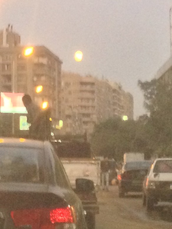 Nearly full moon above Cairo's congested streets.